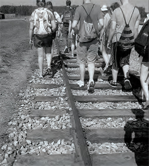 Walking on the tracks at Auschwitz-Birkenau. I’m in the middle wearing white sneakers. Photo by Sam Waldman.