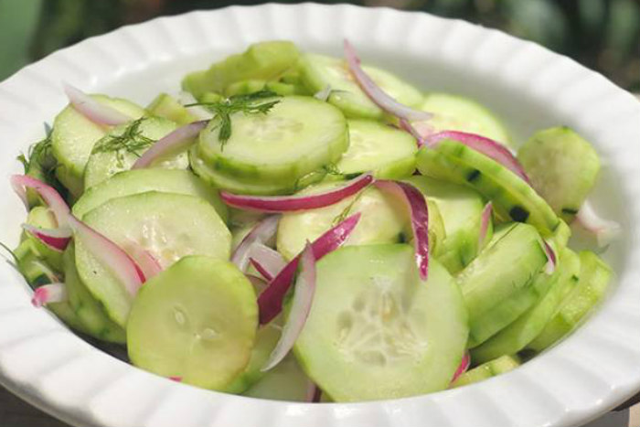 Cucumber salad in a white bowl