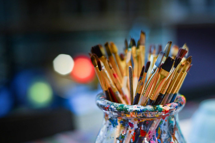 Paintbrushes in a glass vase 