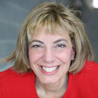 Smiling headshot of Jennifer Laszlo Mizrahi wearing a red top