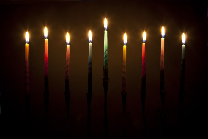 Fully lit menorah in the darkness