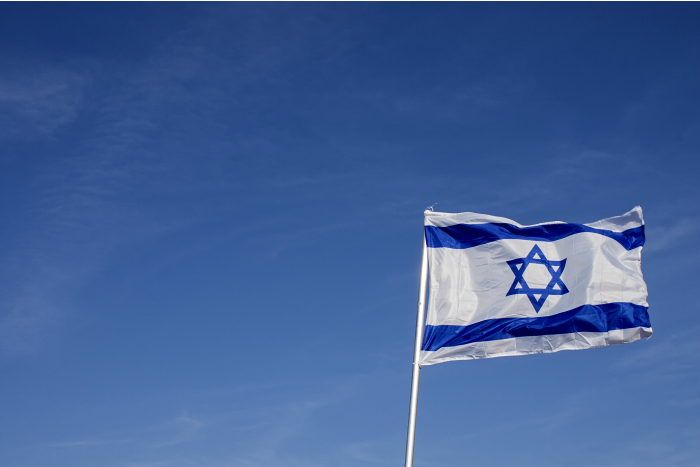 Israeli flag against a blue sky