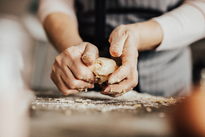 Womans hands kneading dough 