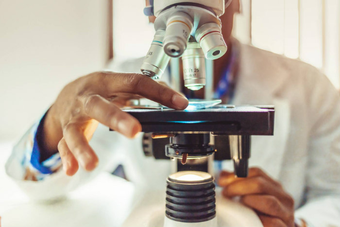 Scientist looking through a microscope