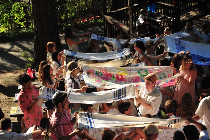 camp counselors reciting the priestly blessing over campers