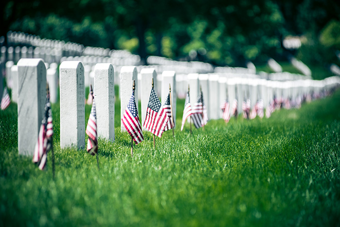 soldiers graves with American flags