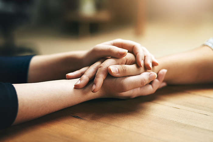 an image of two hands holding one hand