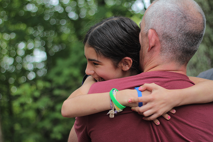 an image of a father and daughter hugging