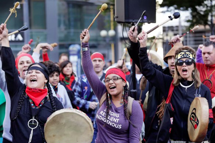 an image of a group of native american people playing instruments 