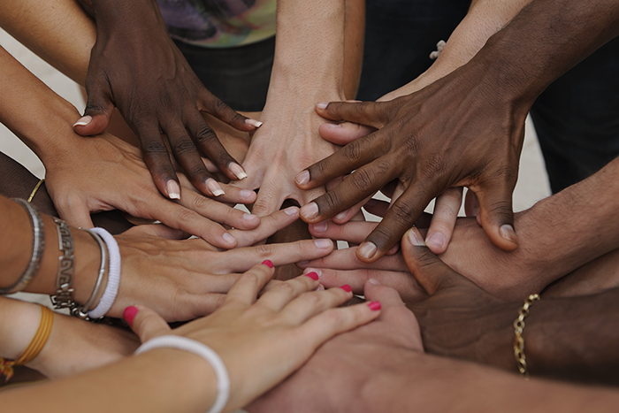 an image of hands of different colors on top of each other