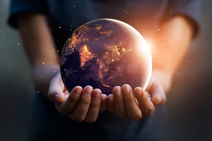 an image of two hands holding a sphere that looks like earth