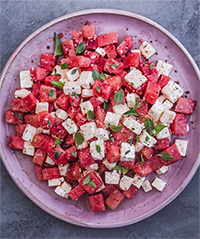 an image of a Watermelon and Bulgarian Cheese Salad on a purple plate