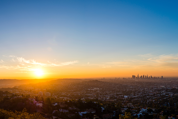 an image of a sun setting over a city