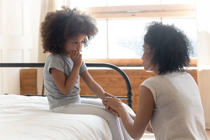 an image of a mother talking to a sick child