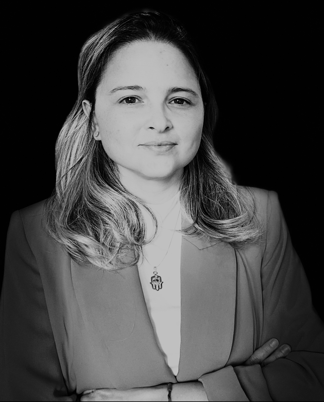 A black and white photo of a woman with shoulder-length hair facing the camera. 