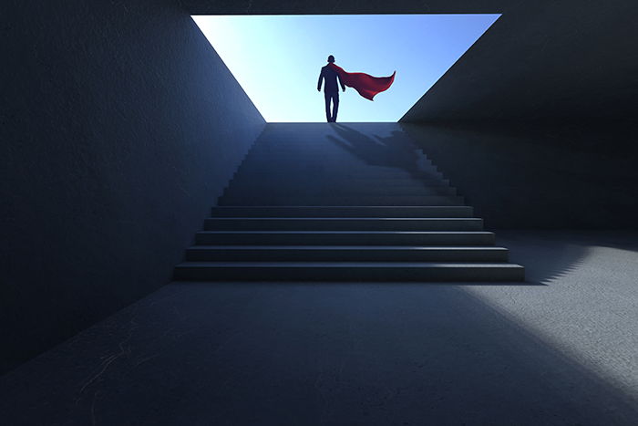 an image of a man wearing a cape standing at the top of a staircase
