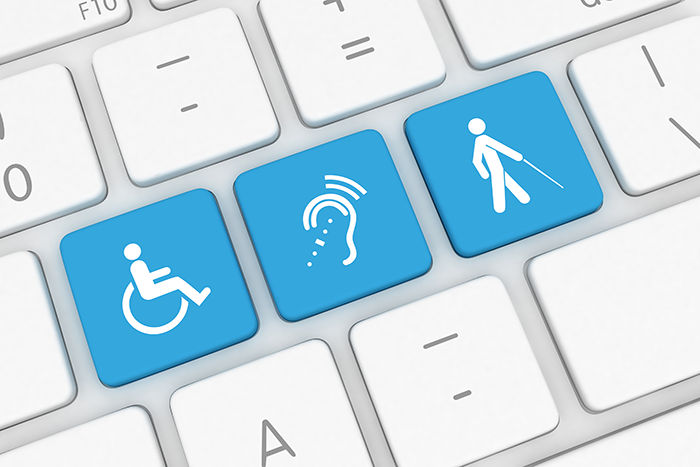 Photo of blue and white keys on a computer keyboard that represent different disabilities