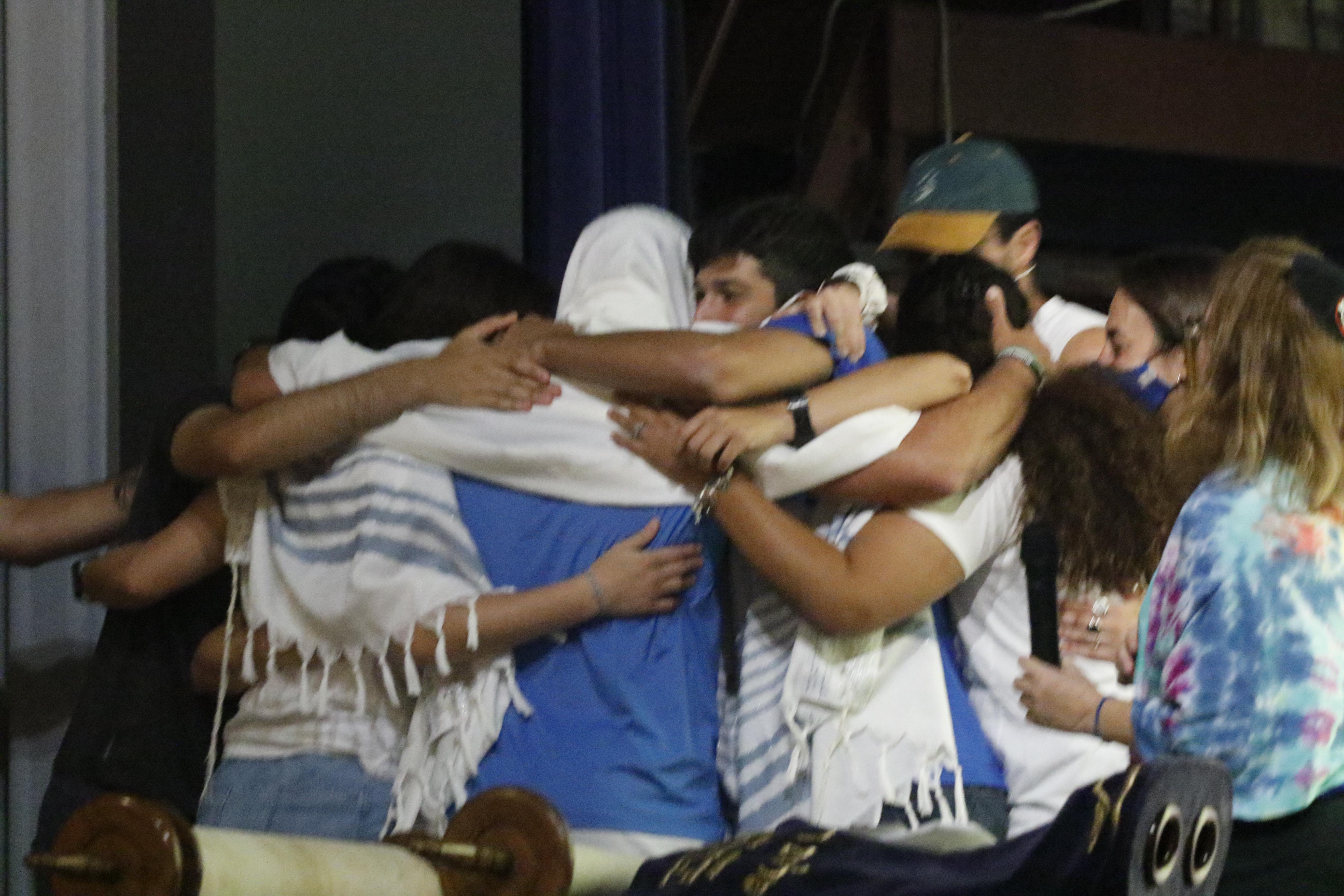 People embracing each other in a circle