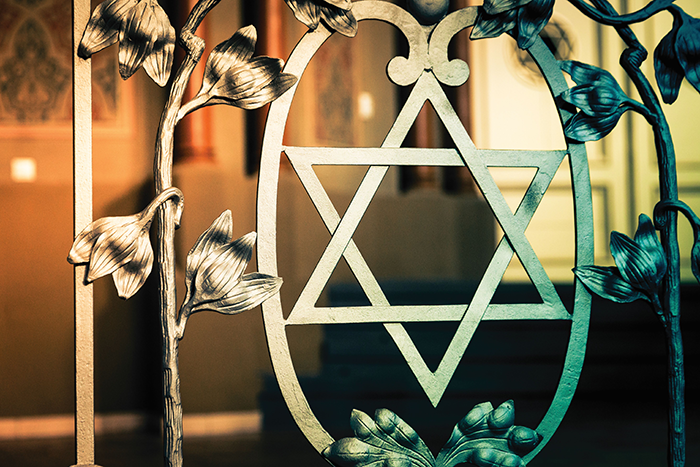Photo of a metal star of david and vines in a synagogue