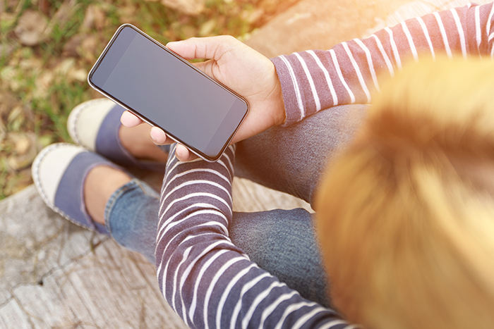 Photo of a person holding a cell phone