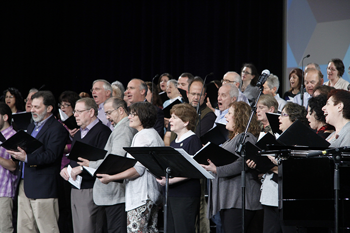 Photo of a group of people singing in a choir