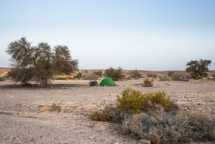 A green tent in the desert