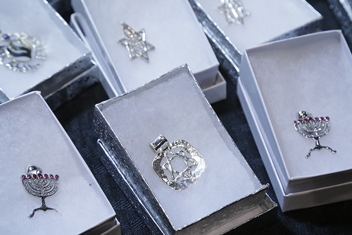 Photo of different necklace charms in the same of Jewish symbols