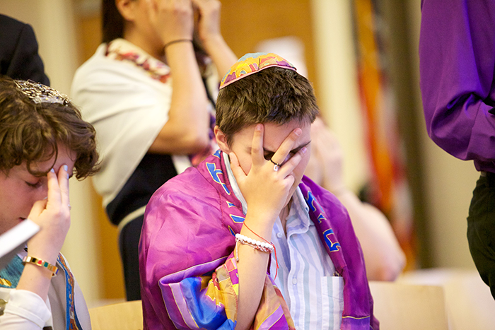 Photo of a man covering his face and praying
