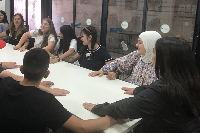 Photo of teens sitting at a table