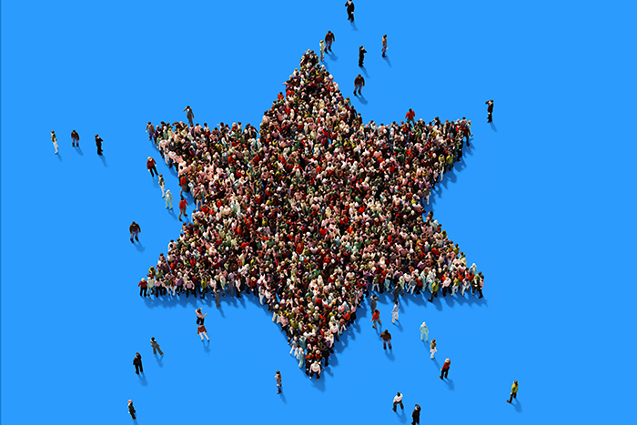 Photo of a lot of people standing in a group shapped like a star of david