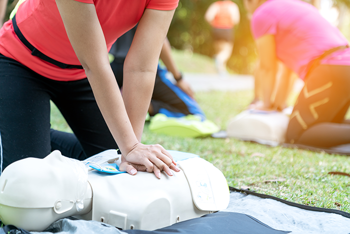 Photo of a woman giving CPR to a CPR dummy