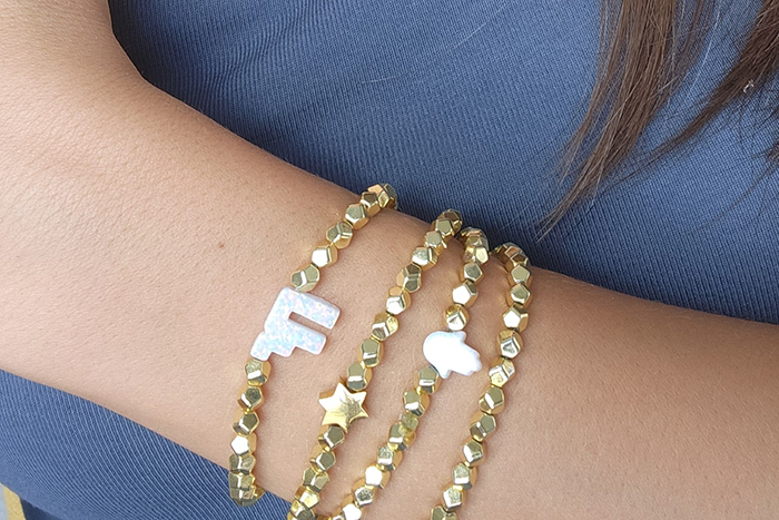 Photo of gold bracelets on a girl's arm