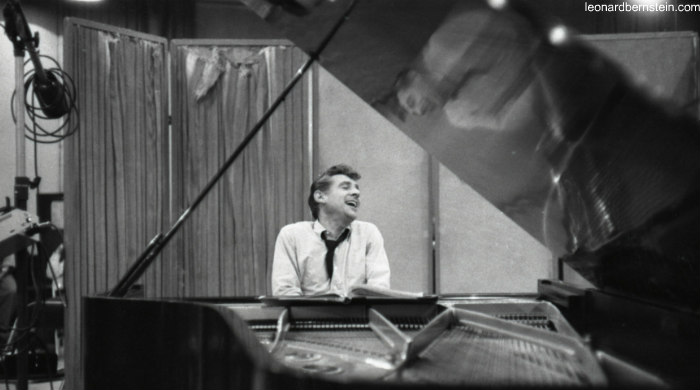 Black and white photo of Leonard Bernstein playing the piano 