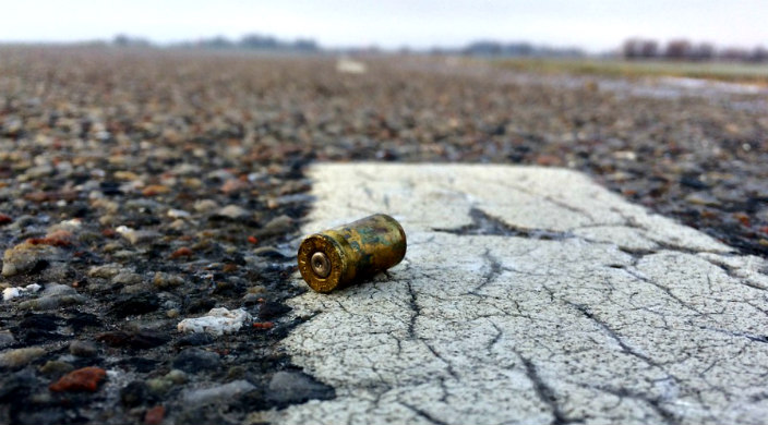 Bullet casing lying on broken ground