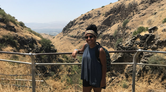 The author smiling while standing in front of scenery in Israel 