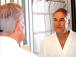 Man looking into mirror at himself to represent self reflection during the Jewish holiday of Yom Kippur