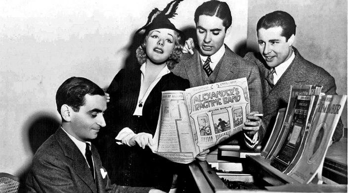Irving Berlin at the piano surrounded by stars from Alexander's Ragtime Band