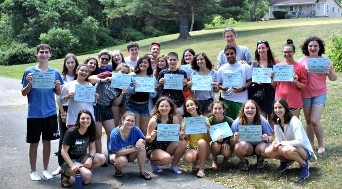 Kutz campers in a group each holding signs about why they vote 