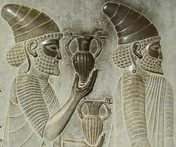 Reliefs in Persepolis showing commoners bearing gifts and wearing floppy hats