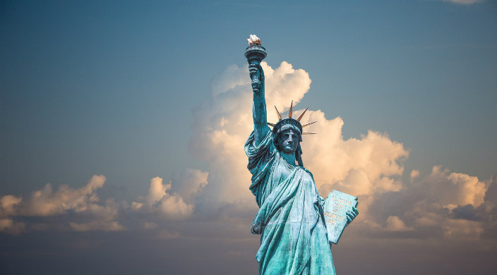 Statue of Liberty against a cloudy blue sky