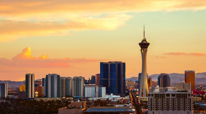 Vegas skyline at twilight against a light orange colored sunset