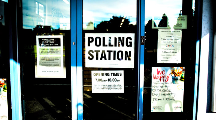 Sign on the window of a polling place 