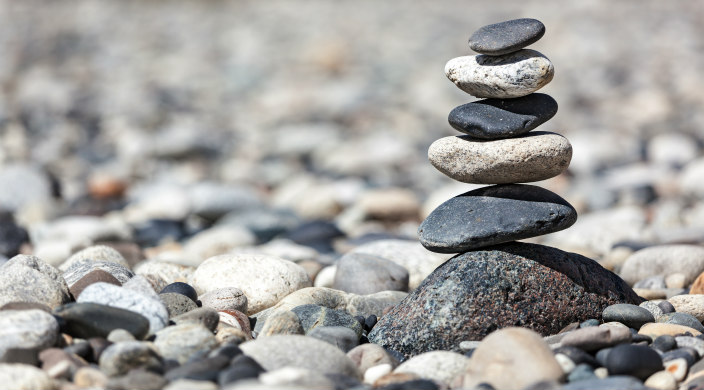 Flat gray and black rocks balanced on top of one another