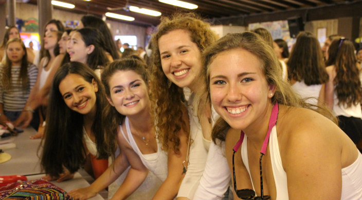 Four girls singing Birkat HaMazon following Shabbat dinner at a URJ camp