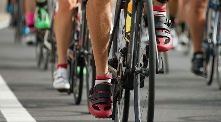 Legs, feet, and bicycles of riders in a cycling race