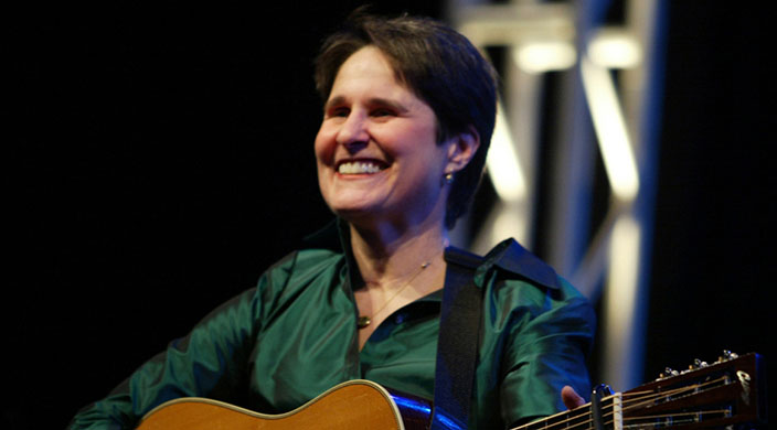 Singer-songwriter Debbie Friedman strumming guitar