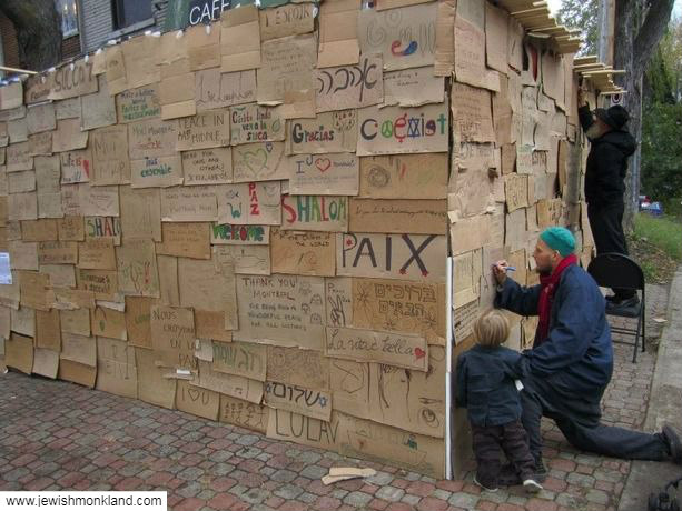 World of Peace sukkah made of cardboard signs