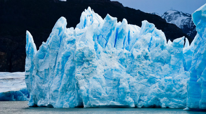 glacier with mountain in the background