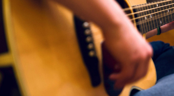 Closeup of a hand strumming a guitar