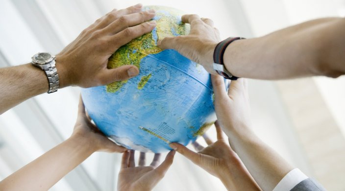 Hands holding up a globe